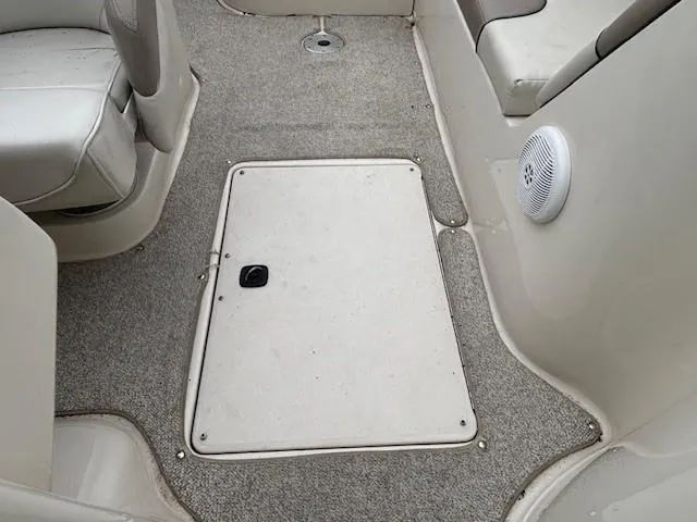 Slide: The Image of 2004 Sea Ray 240 Sundeck interior with carpeted floor and seating. - 22
