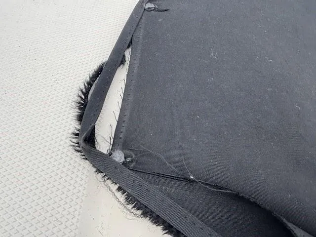 Slide: The Image of Frayed black canvas cover on 2004 Sea Ray 240 Sundeck boat. - 23