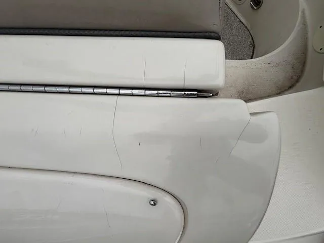 Slide: The Image of 2004 Sea Ray 240 Sundeck boat interior with visible wear and cracks. - 27