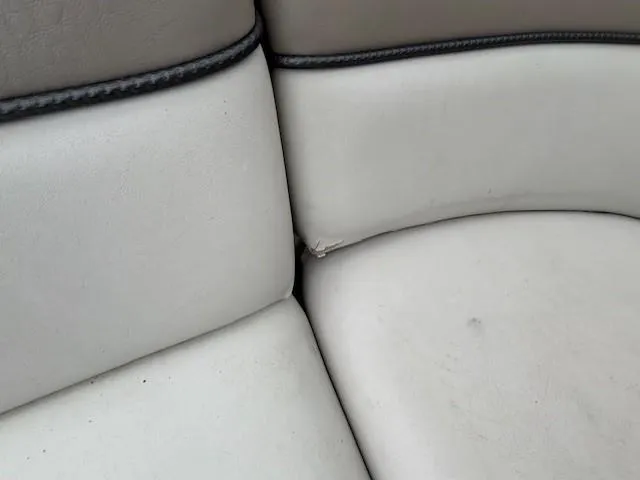 Slide: The Image of Close-up of 2004 Sea Ray 240 Sundeck boat seat with minor wear. - 29