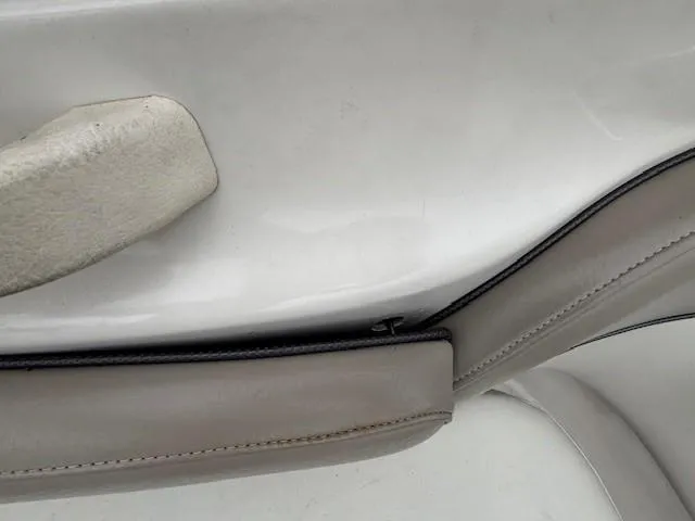 Slide: The Image of 2004 Sea Ray 240 Sundeck interior detail with beige upholstery and trim. - 31