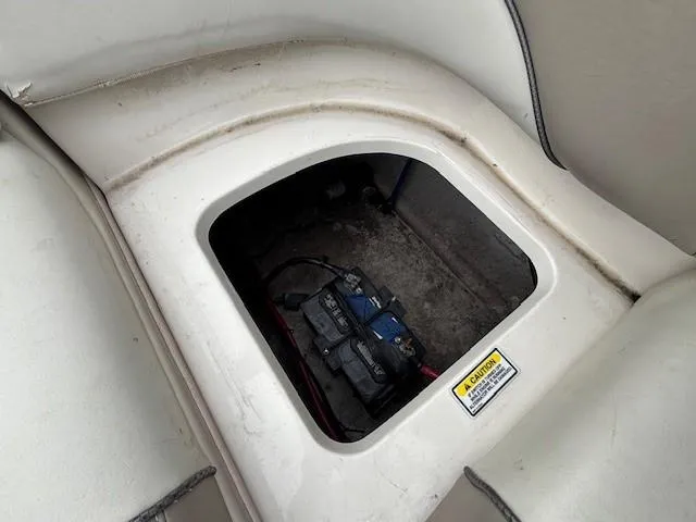 Slide: The Image of Battery compartment of a 2004 Sea Ray 240 Sundeck boat, showing interior details. - 34