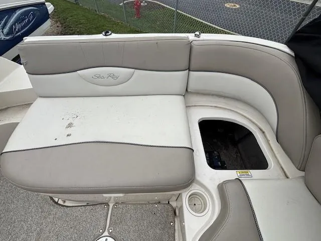 Slide: The Image of 2004 Sea Ray 240 Sundeck boat seating area with storage compartment. - 35