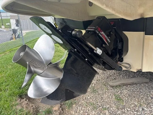 Slide: The Image of Outboard motor of a 2004 Sea Ray 240 Sundeck on gravel and grass. - 37