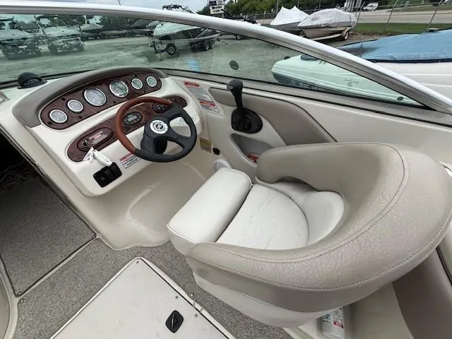 Slide: The Image of 2004 Sea Ray 240 Sundeck boat interior with steering wheel and dashboard controls. - 5