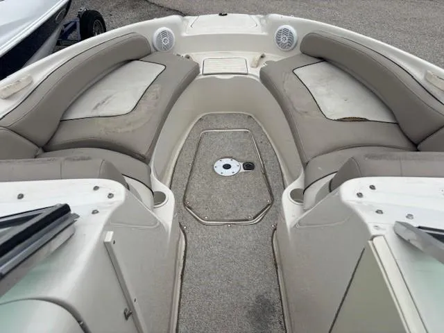 Slide: The Image of 2004 Sea Ray 240 Sundeck interior with cushioned seating and speakers. - 6
