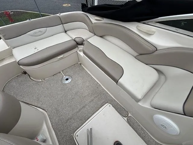 Slide: The Image of 2004 Sea Ray 240 Sundeck interior with beige and gray seating. - 7