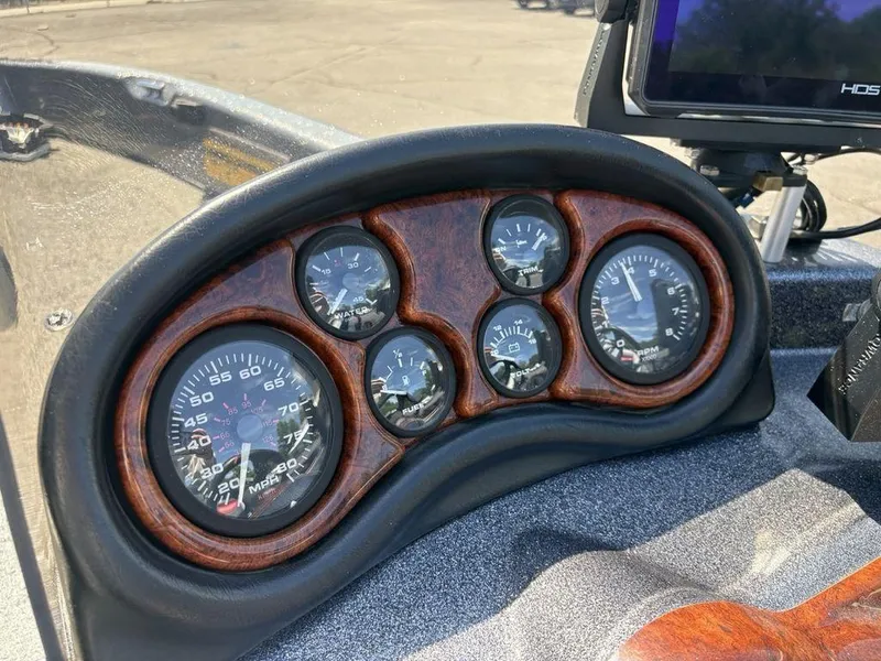 Slide: The Image of Dashboard of a 2000 Triton TR205 DC Walleye boat with gauges and controls. - 12