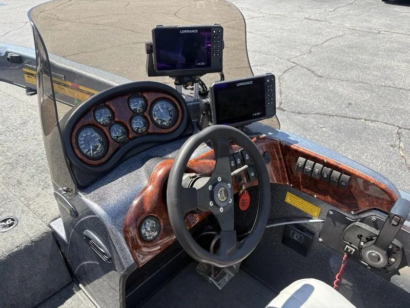 Slide: The Image of Cockpit of 2000 Triton TR205 DC Walleye boat with steering wheel and Lowrance electronics. - 13