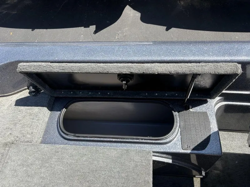 Slide: The Image of Open storage compartment in a 2000 Triton TR205 DC Walleye boat. - 17