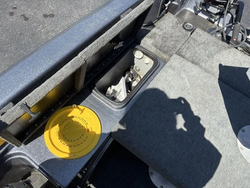 Slide: The Image of Interior of a 2000 Triton TR205 DC Walleye boat showing storage compartments. - 19