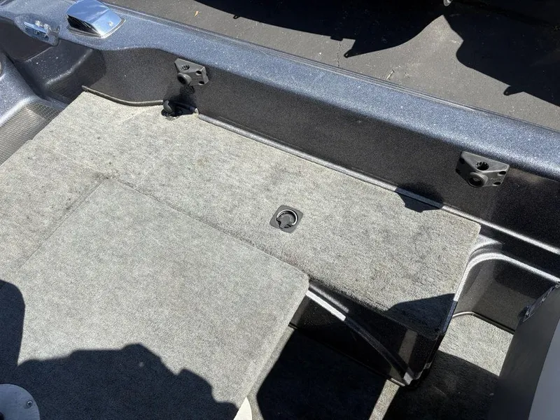 Slide: The Image of 2000 Triton TR205 DC Walleye boat interior with gray carpeted flooring. - 23