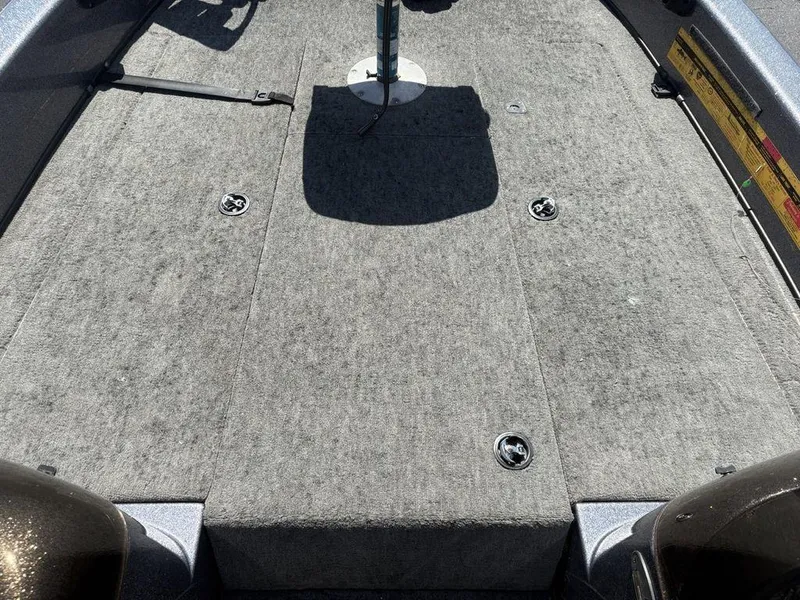 Slide: The Image of 2000 Triton TR205 DC Walleye boat deck with gray carpet and seat base. - 3