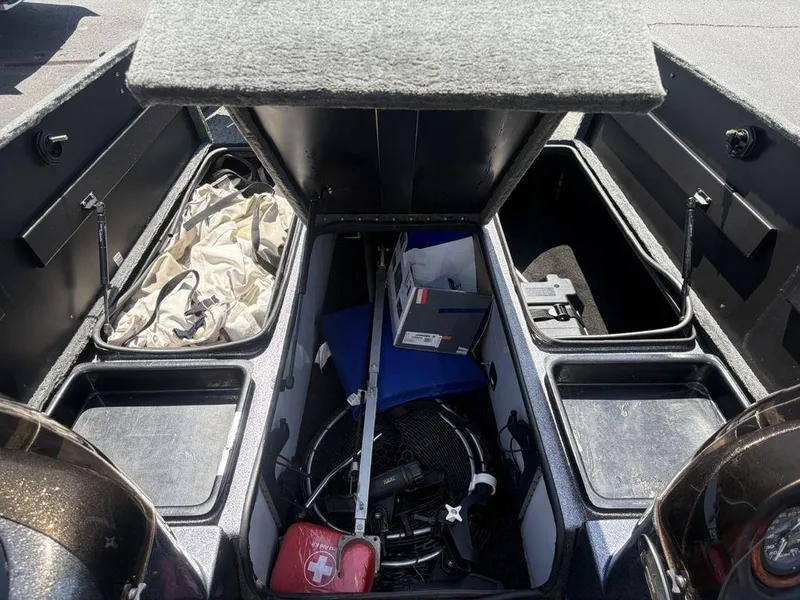 Slide: The Image of 2000 Triton TR205 DC Walleye boat storage compartments with fishing gear and equipment. - 5