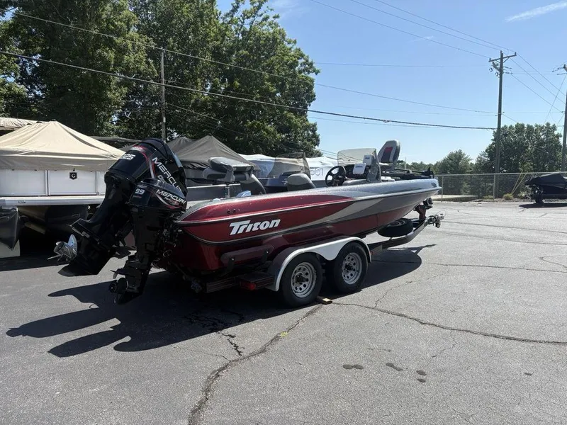 Slide: The Image of 2000 Triton TR205 DC Walleye boat with Mercury engine on trailer in sunny outdoor setting. - 6