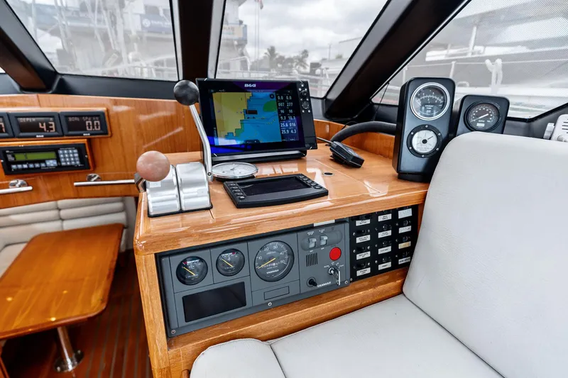 Slide: The Image of Helm of 1998 Custom Kelly Archer yacht with navigation equipment and wooden dashboard. - 10