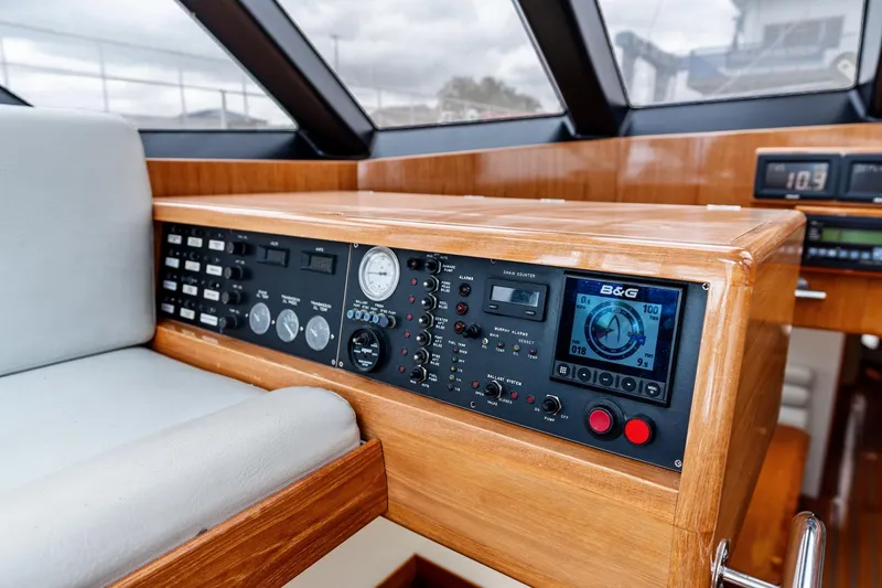 Slide: The Image of Control panel of a 1998 Custom Kelly Archer boat with navigation instruments and gauges. - 11