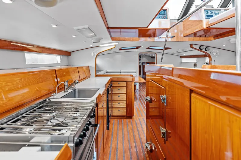 Slide: The Image of Luxurious 1998 Custom Kelly Archer yacht interior with sleek wood finishes and modern kitchen amenities. - 12