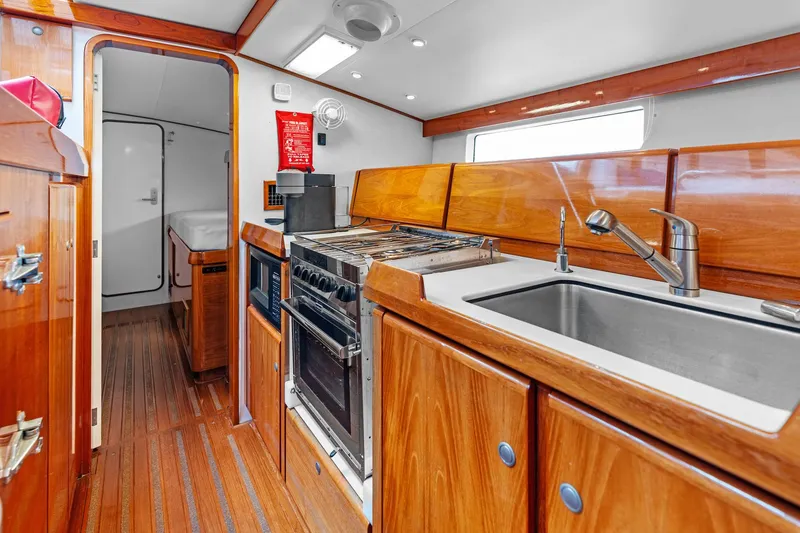 Slide: The Image of Luxurious wooden yacht kitchen interior with modern appliances, Custom Kelly Archer 1998 model. - 14