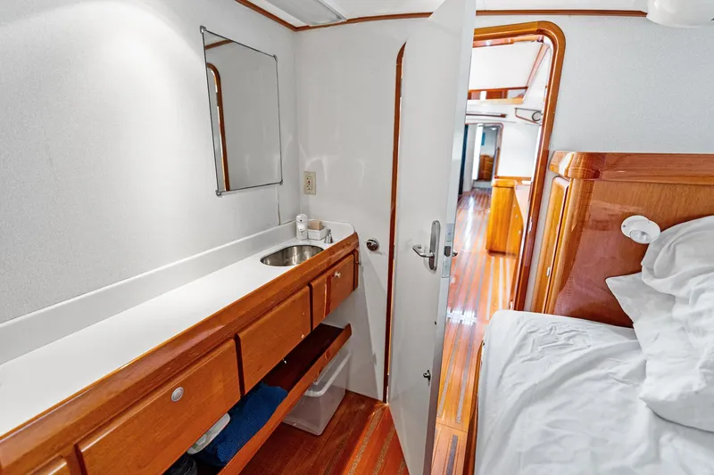 Slide: The Image of Custom Kelly Archer 1998 yacht interior with wooden cabinetry, sink, and cozy sleeping area. - 28