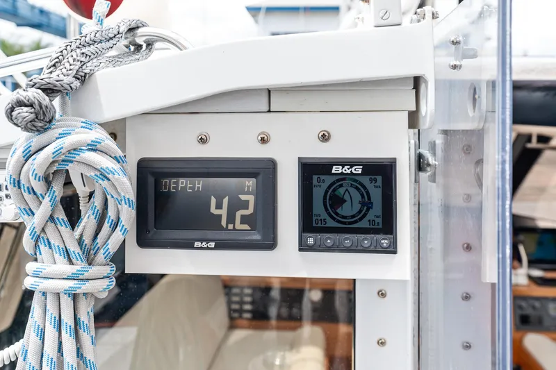 Slide: The Image of Digital navigation instruments on a 1998 Custom Kelly Archer boat, displaying depth and compass readings. - 3