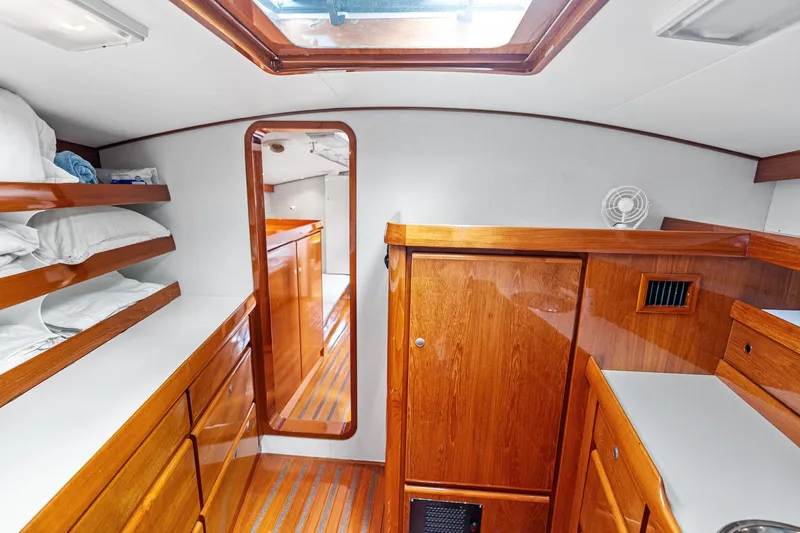 Slide: The Image of Luxurious wooden interior of 1998 Custom Kelly Archer yacht cabin with storage and bedding. - 30