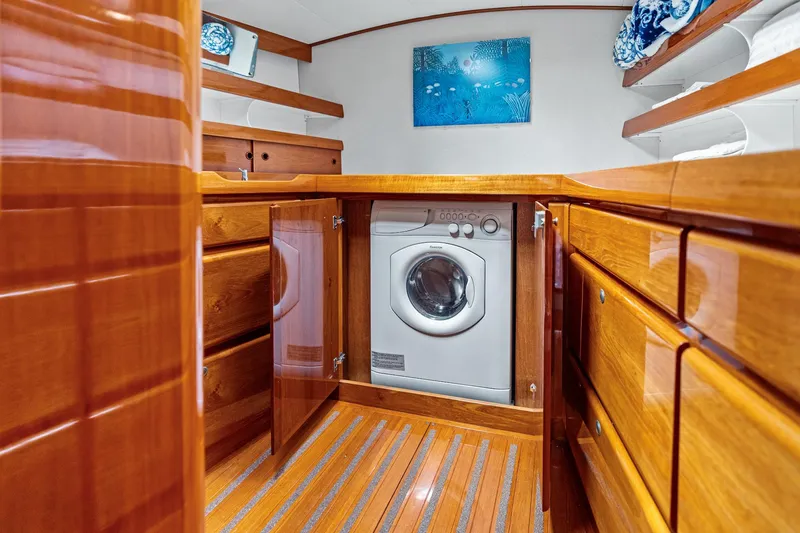 Slide: The Image of Laundry area on a 1998 Custom Kelly Archer yacht with wooden cabinetry and washing machine. - 31