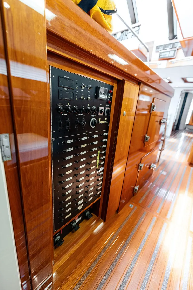 Slide: The Image of Electrical control panel on a 1998 Custom Kelly Archer yacht with polished wooden interior. - 33