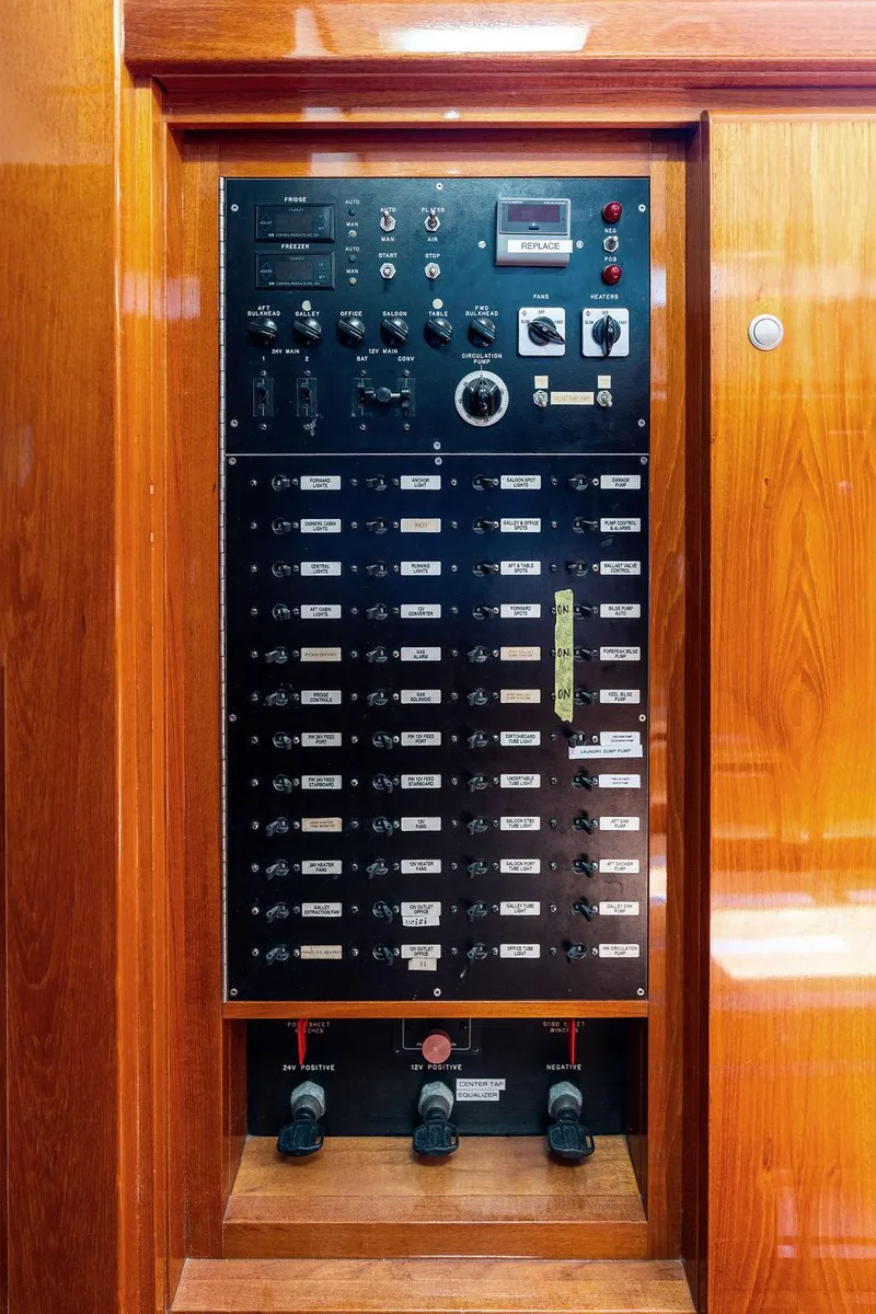 Slide: The Image of Electrical control panel on a 1998 Custom Kelly Archer boat, featuring switches and gauges. - 34