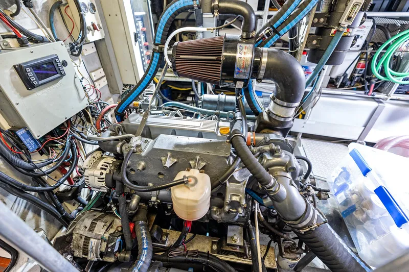 Slide: The Image of Engine room of a 1998 Custom Kelly Archer, showcasing complex machinery and wiring. - 35