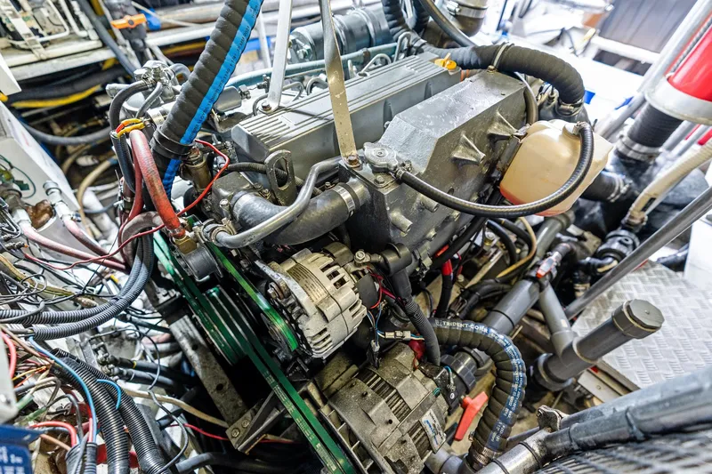 Slide: The Image of Engine room of a 1998 Custom Kelly Archer boat, showcasing complex machinery and wiring. - 38