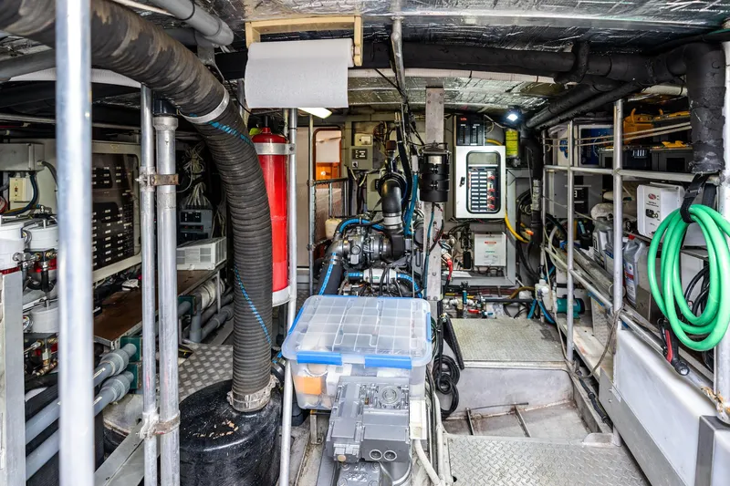 Slide: The Image of Engine room of a 1998 Custom Kelly Archer boat, featuring equipment and storage. - 39