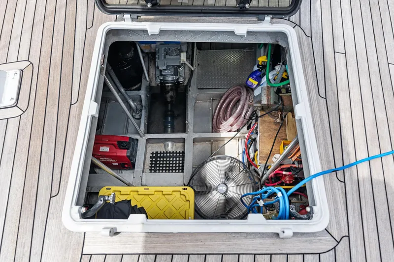 Slide: The Image of Open hatch on 1998 Custom Kelly Archer boat, revealing storage and equipment. - 48