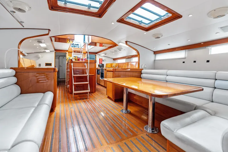 Slide: The Image of Luxurious 1998 Custom Kelly Archer yacht interior with wooden flooring and plush seating. - 6