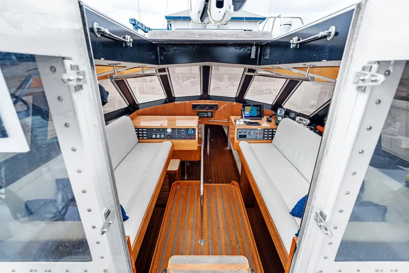 Slide: The Image of Interior of 1998 Custom Kelly Archer boat with wooden flooring and modern navigation equipment. - 8