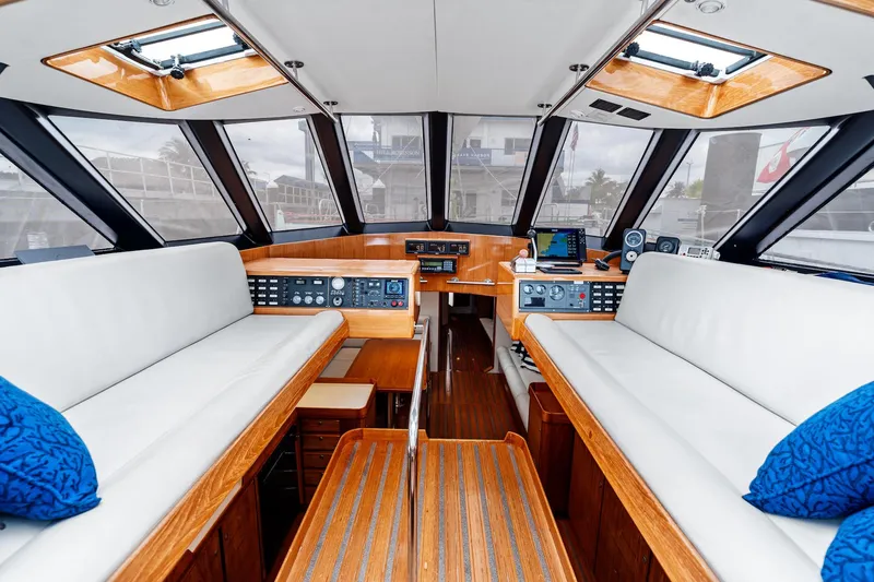 Slide: The Image of Luxurious 1998 Custom Kelly Archer yacht interior with white seating and wooden accents. - 9