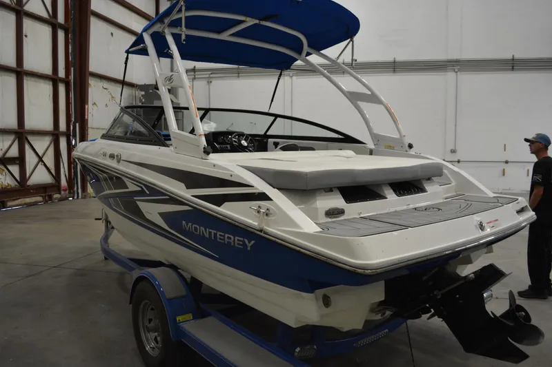 Slide: The Image of 2018 Monterey M-20 boat in warehouse, blue and white design, on trailer. - 3