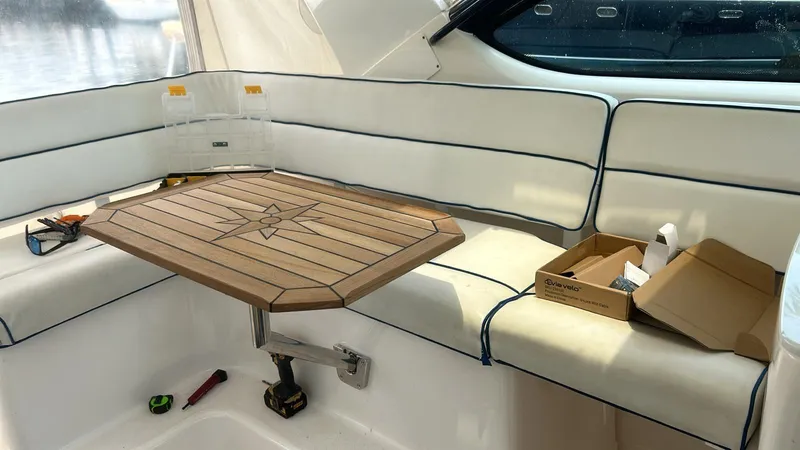 Slide: The Image of 2008 Tiara Yachts 3800 Open interior with wooden table and white seating. - 16