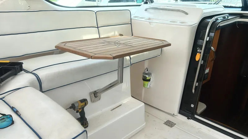 Slide: The Image of 2008 Tiara Yachts 3800 Open interior with wooden table and white seating. - 17