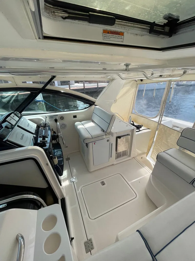 Slide: The Image of 2008 Tiara Yachts 3800 Open interior with helm and seating area. - 19
