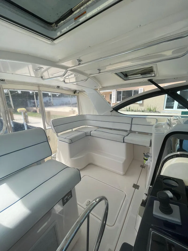 Slide: The Image of Interior of 2008 Tiara Yachts 3800 Open, featuring white seating and modern design. - 7