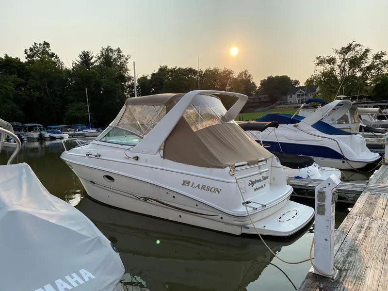 The Image of 2001 Larson Cabrio 270 boat docked at marina during sunset. - 0