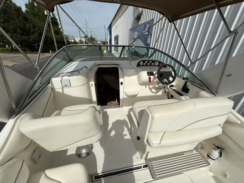 Slide: The Image of Interior of a 2001 Larson Cabrio 270 yacht with white seating. - 11