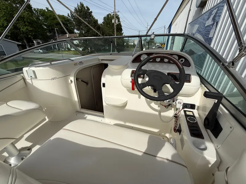 Slide: The Image of Interior of a 2001 Larson Cabrio 270 yacht with steering console. - 14