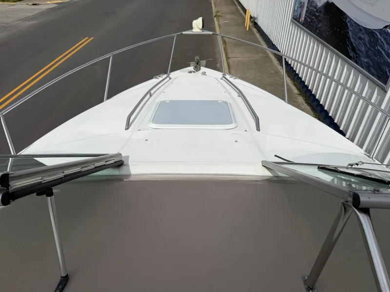 Slide: The Image of 2001 Larson Cabrio 270 boat parked on a street. - 16