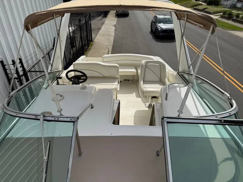 Slide: The Image of 2001 Larson Cabrio 270 boat with canopy parked on street. - 19