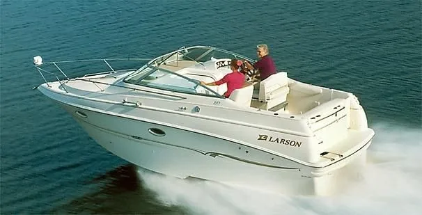Slide: The Image of 2001 Larson Cabrio 270 boat cruising on open water with two passengers. - 2