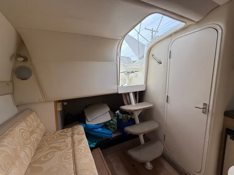 Slide: The Image of Interior of a 2001 Larson Cabrio 270 yacht with stairs and seating area. - 21
