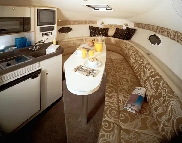 Slide: The Image of Interior of 2001 Larson Cabrio 270 boat with kitchenette and cozy seating area. - 3