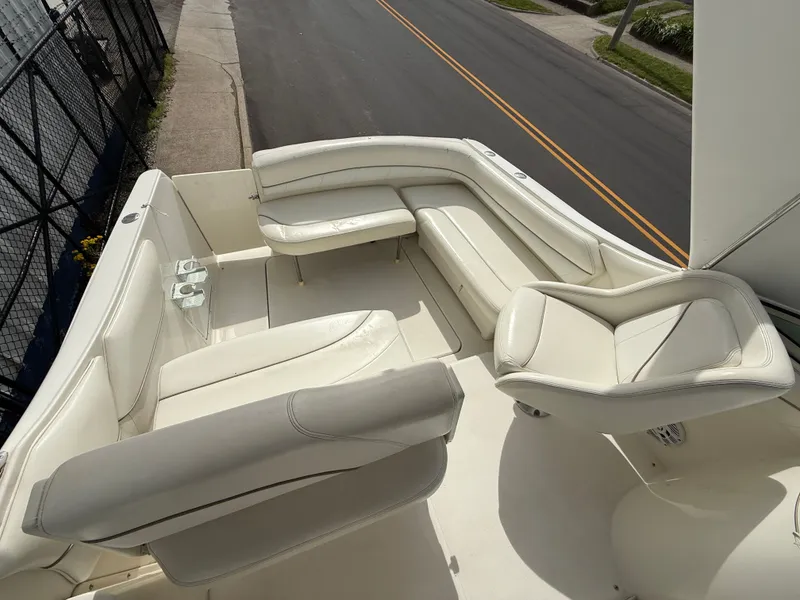 Slide: The Image of Interior of a 2001 Larson Cabrio 270 with white leather seating. - 9